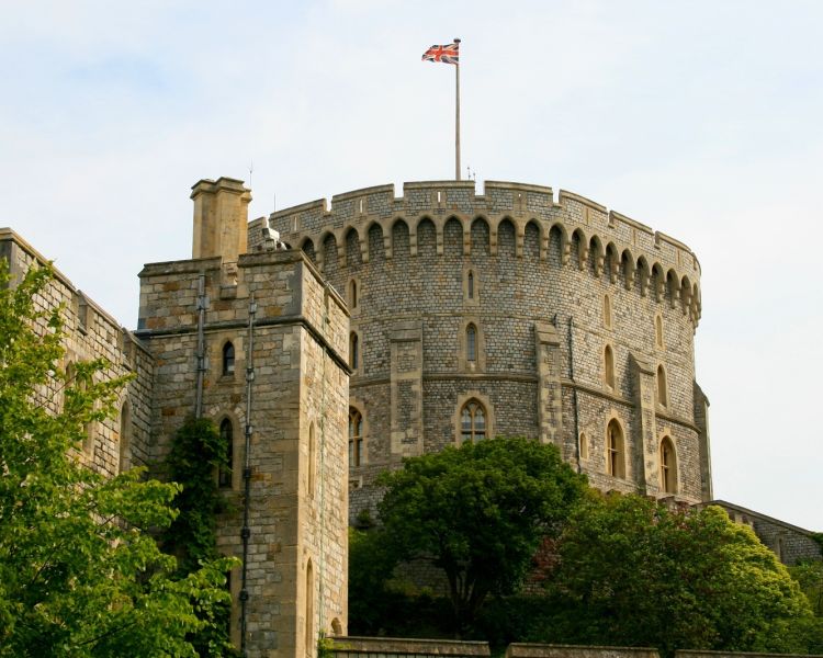 view of one of the towers of windsor castle with flag on top