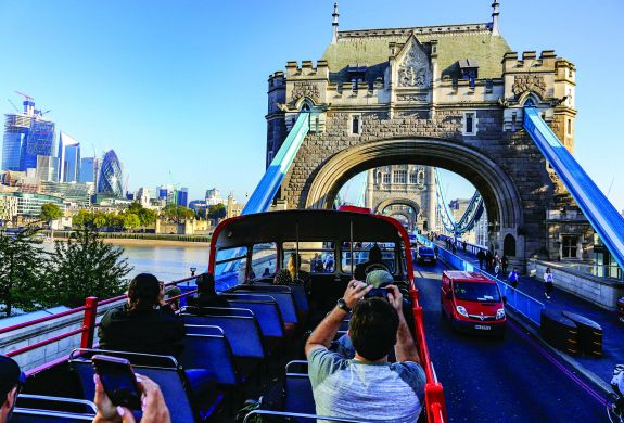 london tour bus going over tower bridge