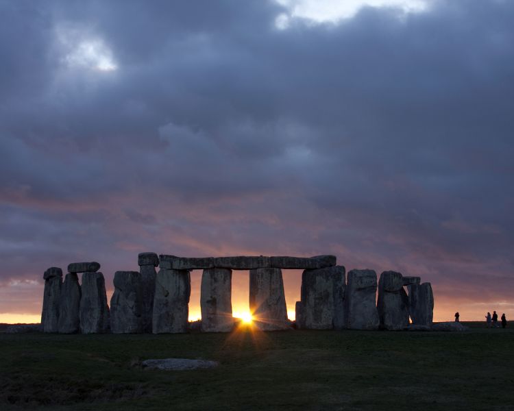 stonehenge with sun rising behind the stones