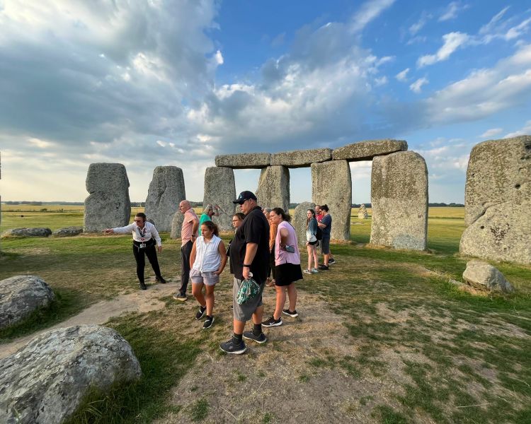 people visiting stonehenge standing inside the stone circle