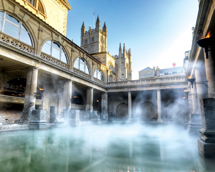 the roman baths in bath with steam rising off of the water