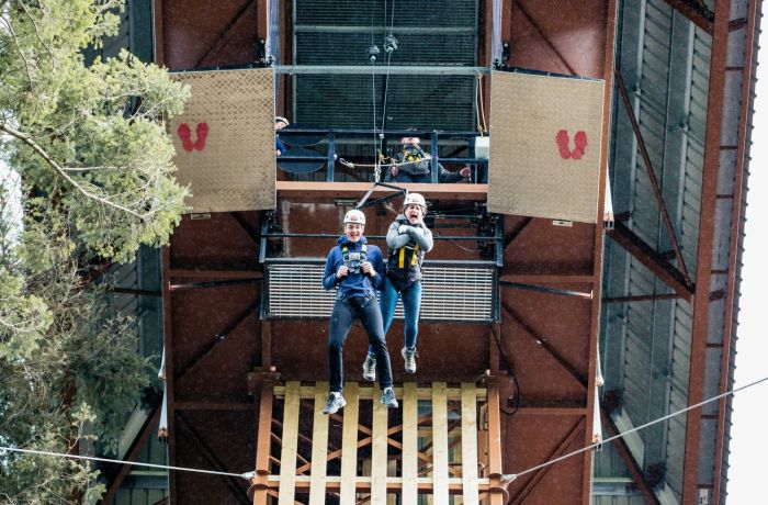 two people doing the plummet free fall experience at zip world