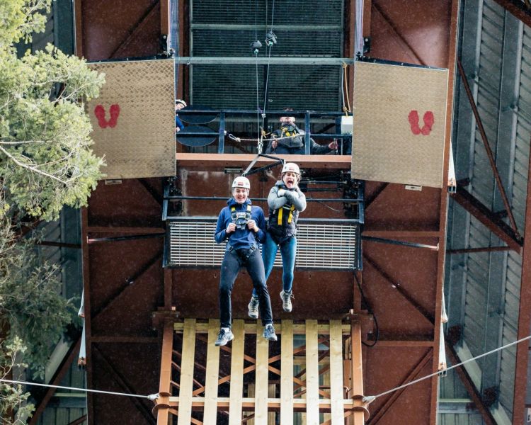 two people doing the plummet free fall experience at zip world