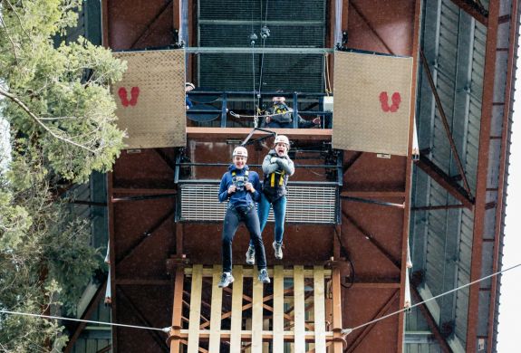 two people doing the plummet free fall experience at zip world