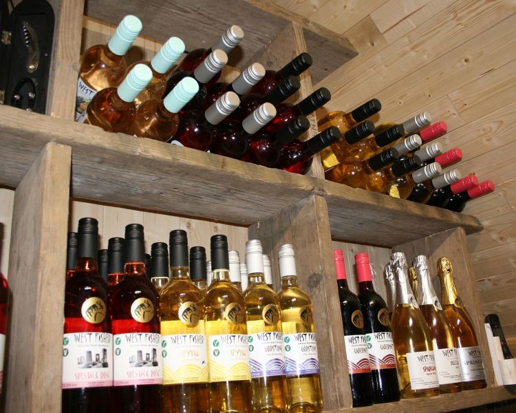 bottles of wine on shelf for a wine tasting experience in kent