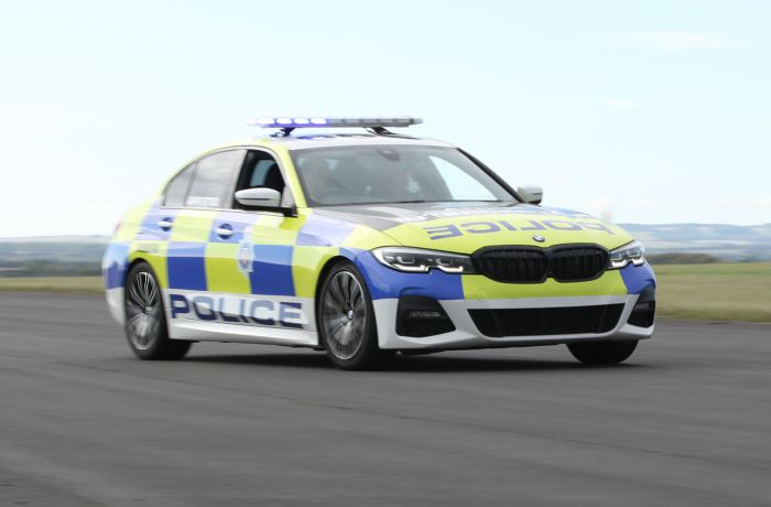 a uk police car driving along a track for a police car driving experience