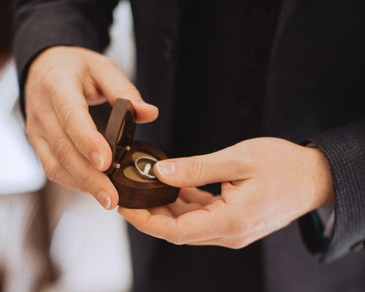 man holding a ring box as part of a ring making experience day