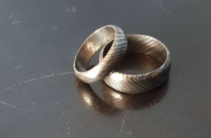 two patterned damascus rings made on a damascus ring making experience day