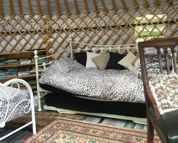 the inside of one of the devon yurts with beds and carpets