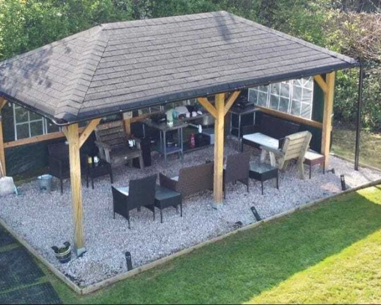 the field kitchen with outdoor seating area and food prep area at the devon yurts complex