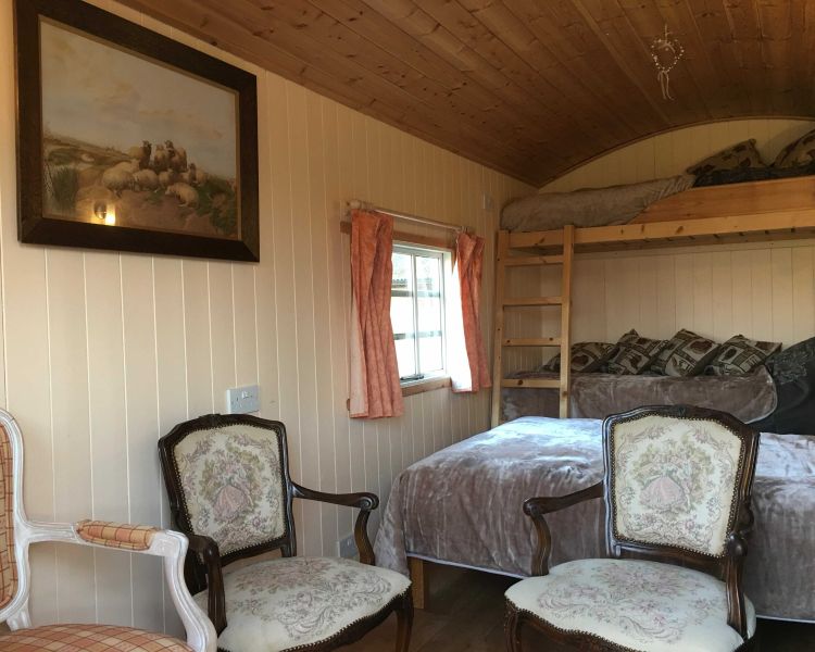 a view inside a shepherds hut set in the grounds of devon yurts