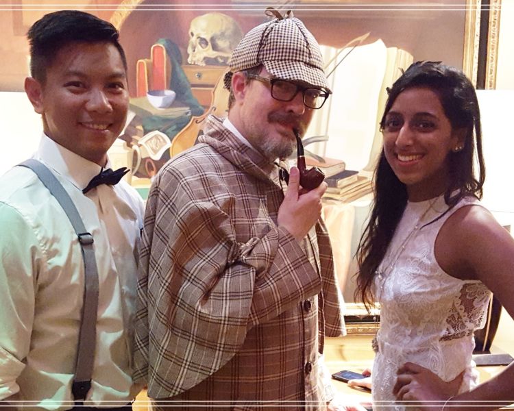 guests in fancy dress including a man dressed as sherlock on a murder mystery weekend experience