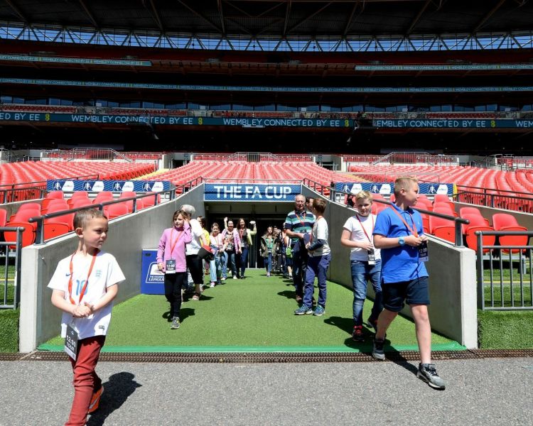 tour group walking out the players tunnel on a wembley stadium tour