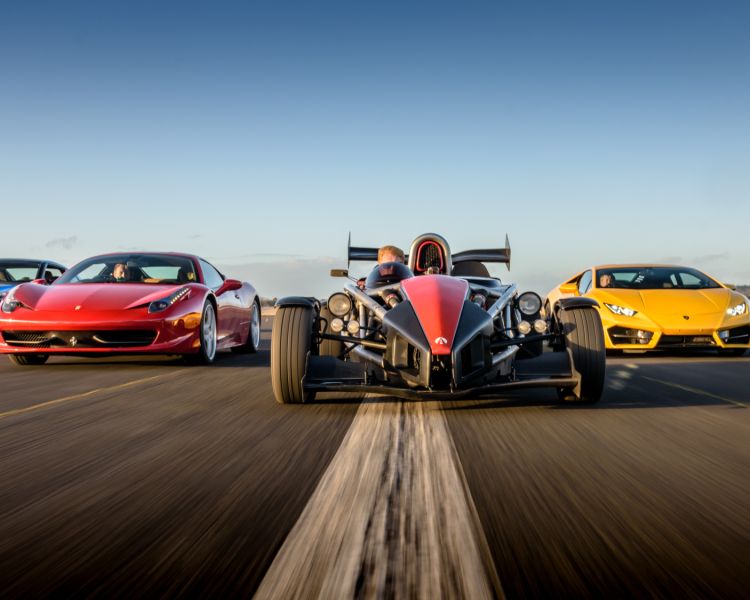 a selection of supercars on a race track at car chase heroes driving experience day