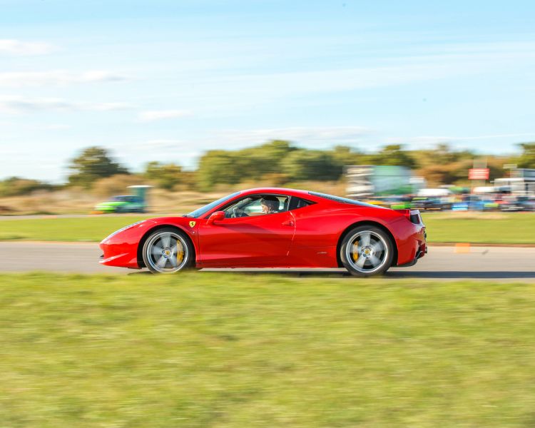 a red supercar on a race track at car chase heroes driving experience day