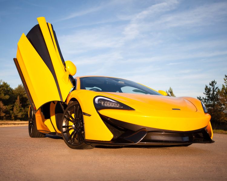 yellow supercar with drivers door lifted up at car chase heroes driving experience day