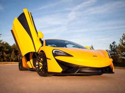 yellow supercar with drivers door lifted up at car chase heroes driving experience day