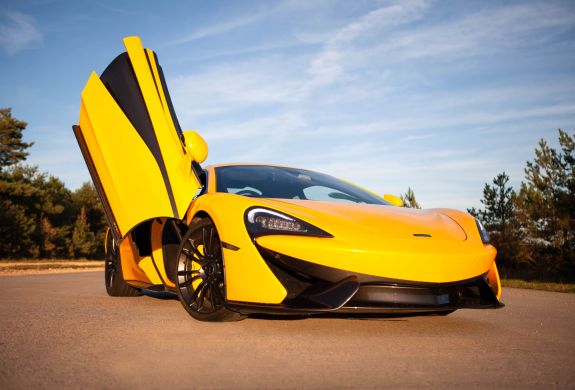 yellow supercar with drivers door lifted up at car chase heroes driving experience day