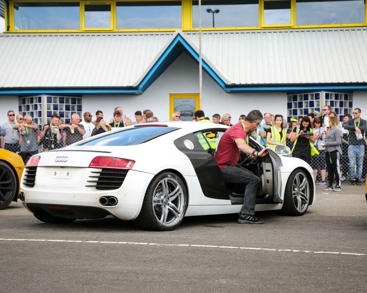 man getting out of a white supercar at car chase heroes driving experience day