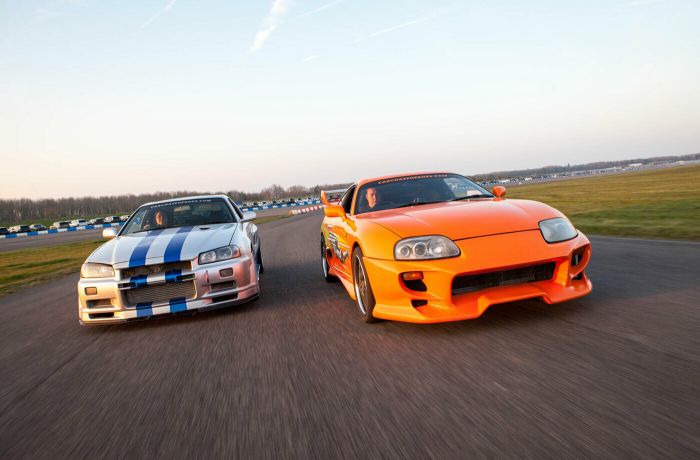 two movie inspired sports cars on a race track for a movie car track driving experience day