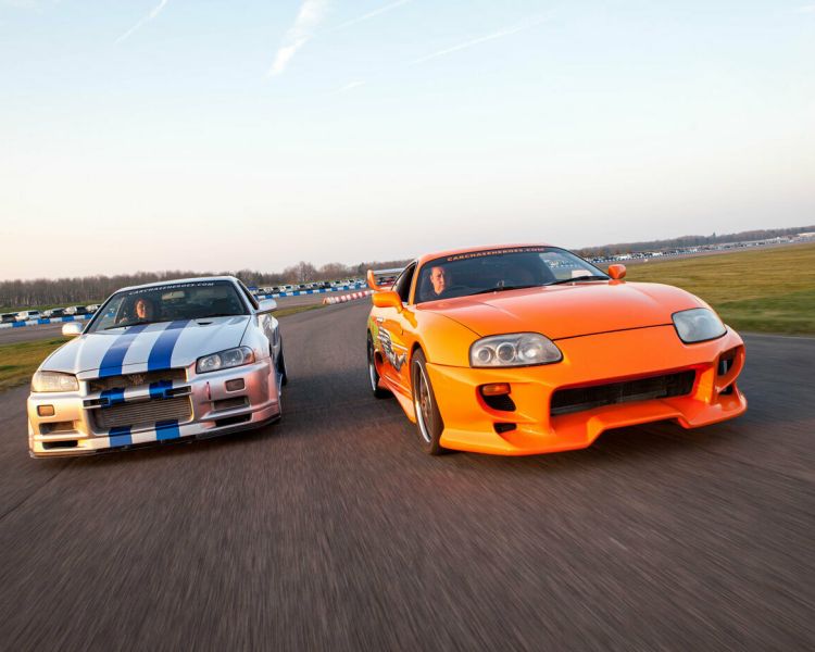 two movie inspired sports cars on a race track for a movie car track driving experience day