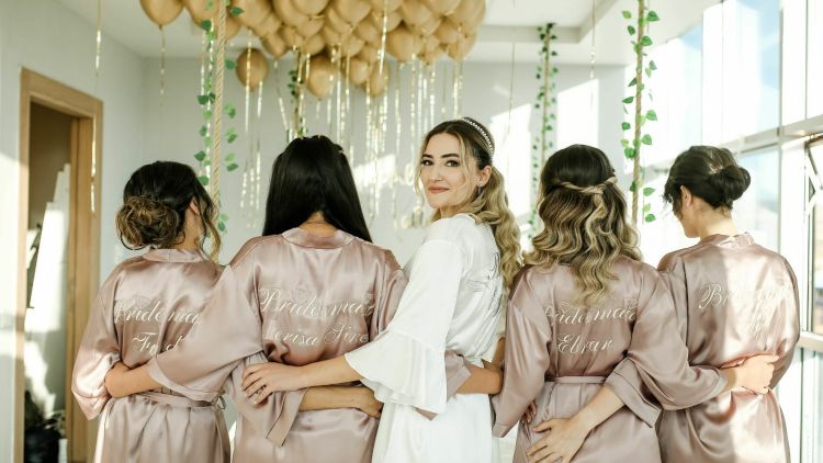 Bride to be looking at camera with bridesmaids at her side
