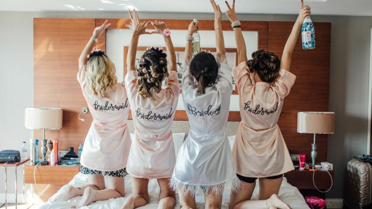 bride and bridesmaids wearing personalised dressing gowns