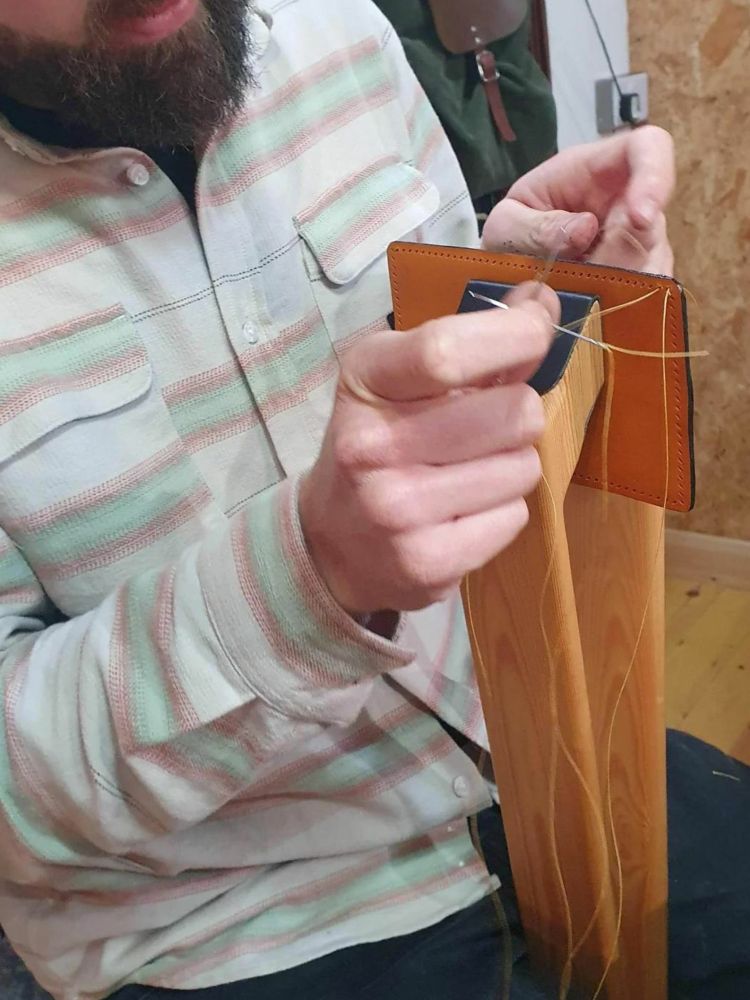 Man making leather wallet