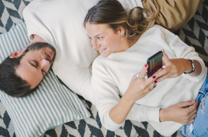 man lying on the floor with girlfriend lying with her head on his chest on valentines day