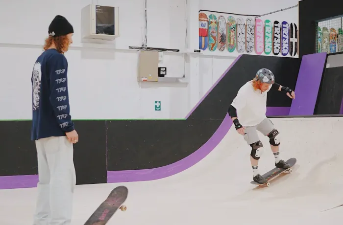 man on a skateboard lesson experience day watched by instructor