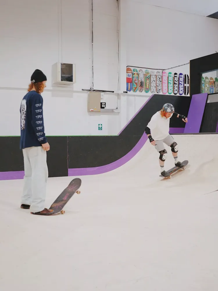 man on a skateboard lesson experience day watched by instructor
