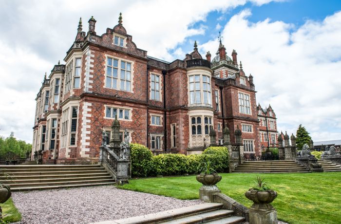 exterior of q hotels crewe hall with manicured gardens surrounding it
