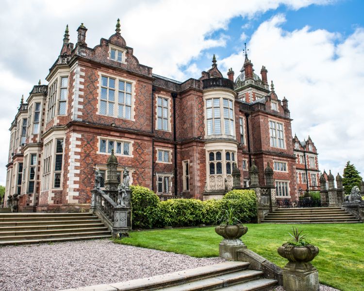 exterior of q hotels crewe hall with manicured gardens surrounding it