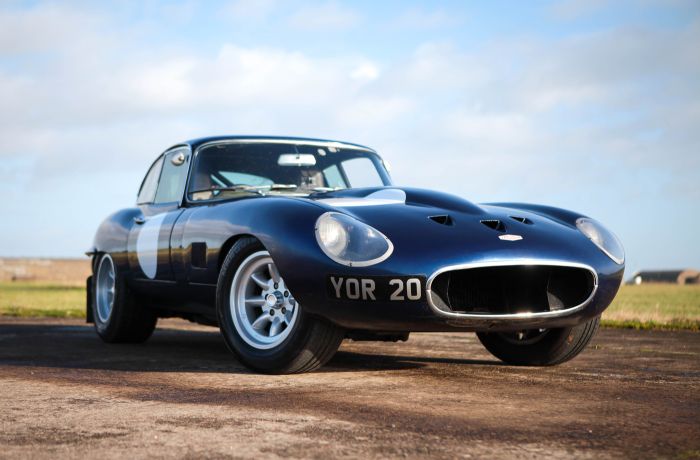 an e type blue jaguar on the edge of a race track as part of a driving experience day