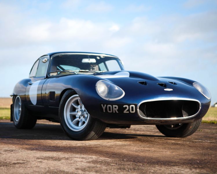 an e type blue jaguar on the edge of a race track as part of a driving experience day