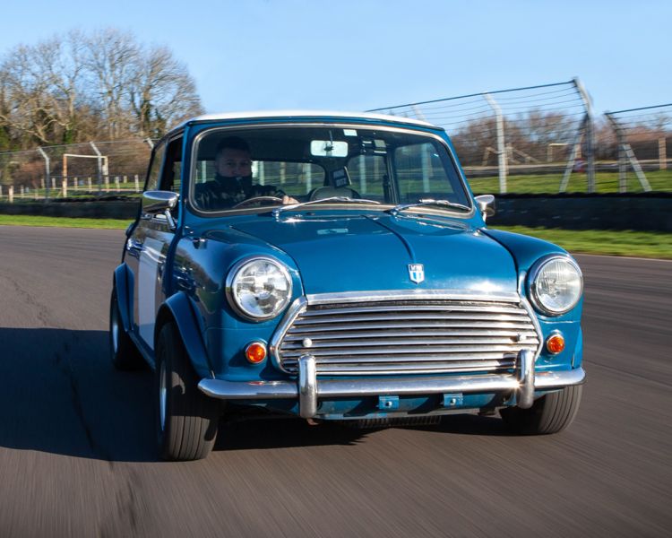 a blue mini cooper on a race track as part of a driving experience day