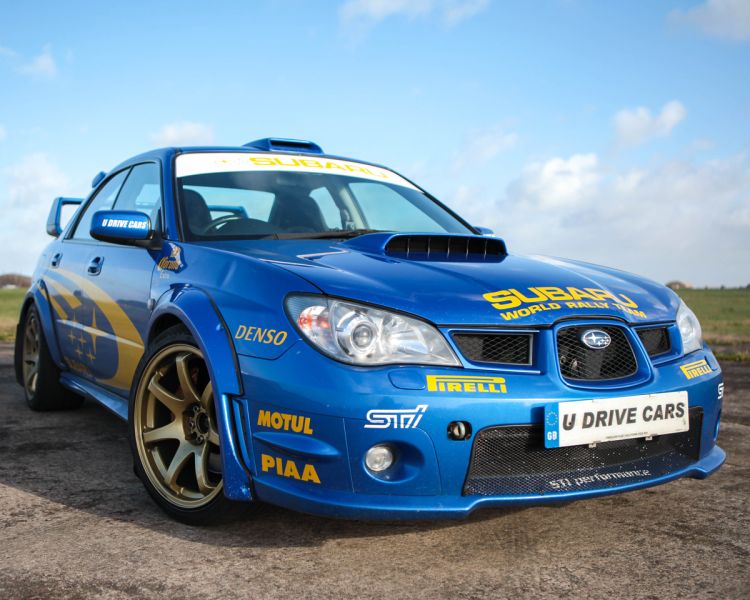 a blue Subaru on a race track as part of a driving experience