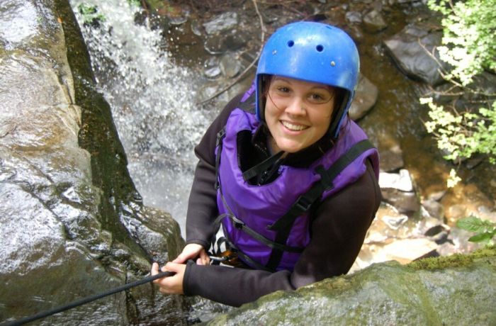 woman enjoying a canyoning descent experience day