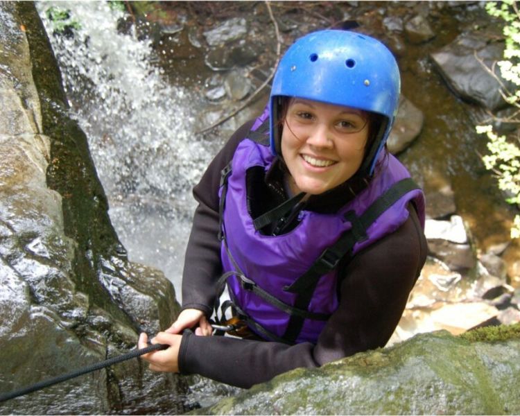 woman enjoying a canyoning descent experience day