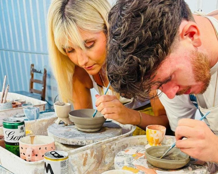 two people painting pottery on a pottery painting experience in london