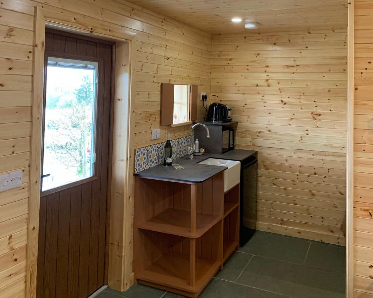 the simple kitchen area in the glamping hut in the lake district