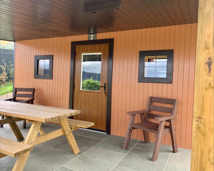 the front of the glamping hut in the lake district with picnic bench