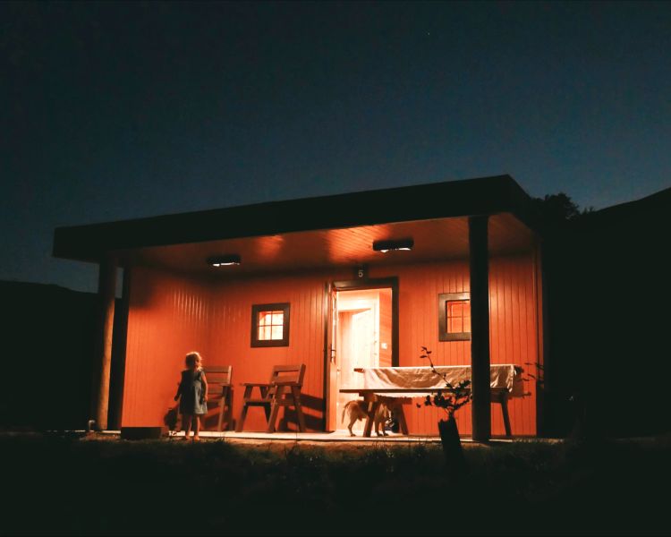front view of the glamping hut in the lake district lit up at night