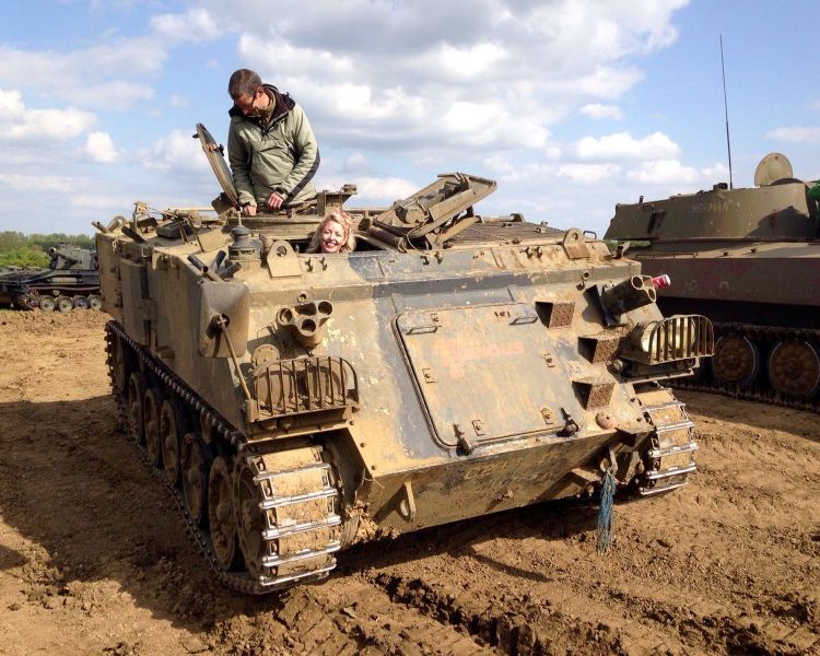 woman driving a military tank on a tank driving experience day