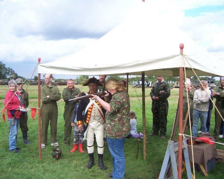 a woman firing 17th century flinklocks and mortars on a tank driving experience day