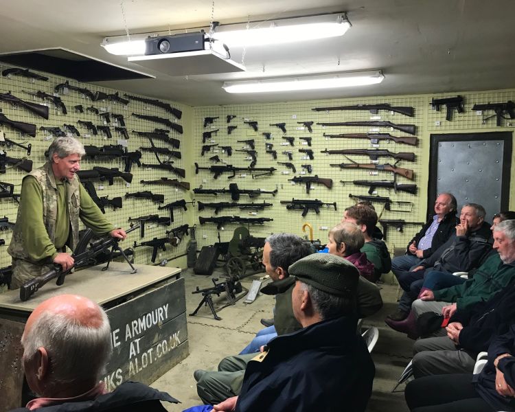 people being given a tour of the armoury on a tank driving experience day