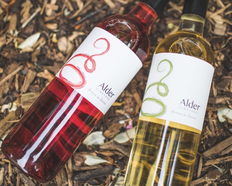 a bottle or red and a bottle of white wine from alder vineyard in devon
