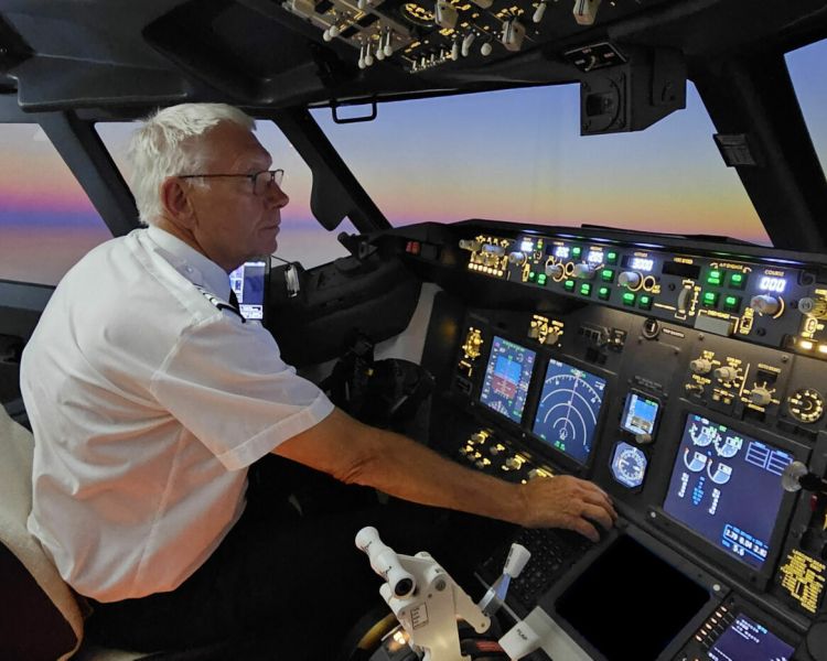 man at the controls of a Boeing 737 - 800NG flight simulator experience