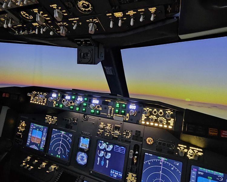 view of a sunset from the cockpit of a Boeing 737 - 800NG on a simulator experience