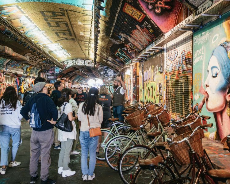 a sightseeing bike tour stopped inside the banksy tunnel to see the graffiti